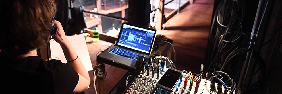 Student sitting stage lighting console